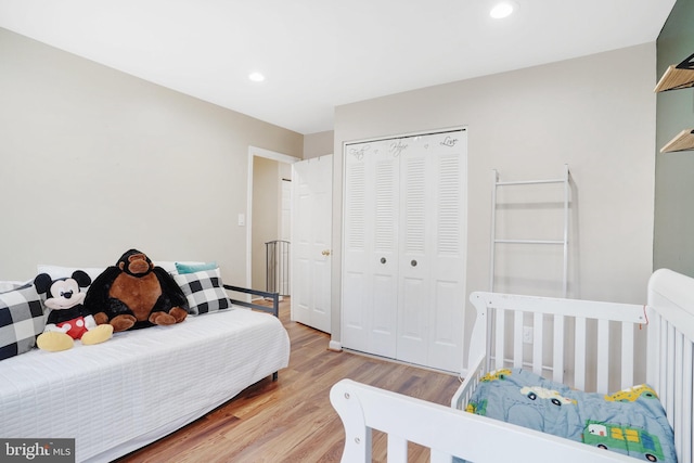 bedroom with a closet and light hardwood / wood-style flooring