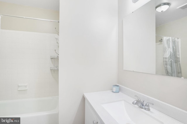 bathroom featuring vanity and shower / tub combo with curtain