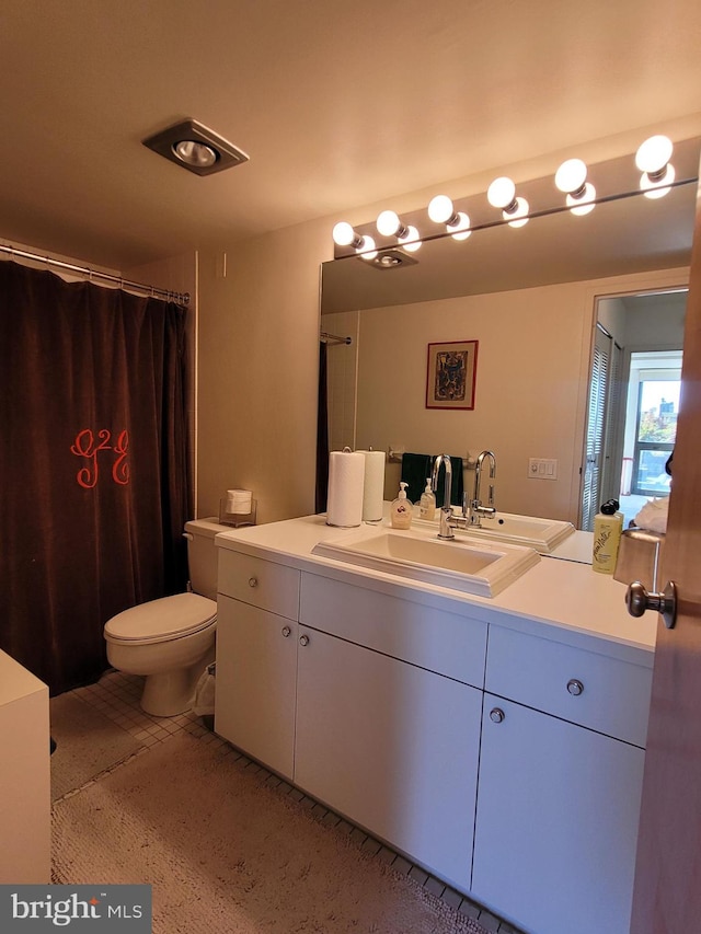 bathroom featuring toilet and vanity