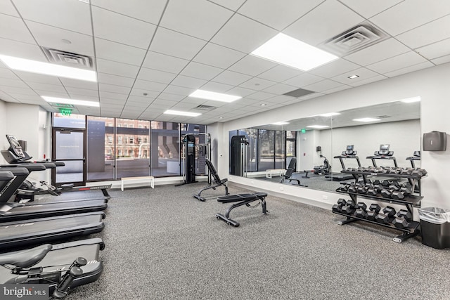 exercise room with a paneled ceiling