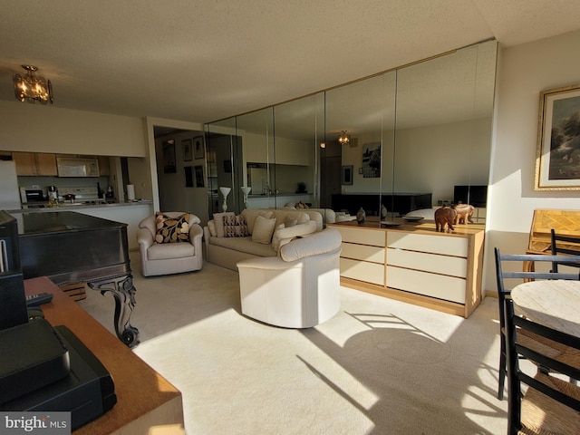 living room with light colored carpet and a textured ceiling