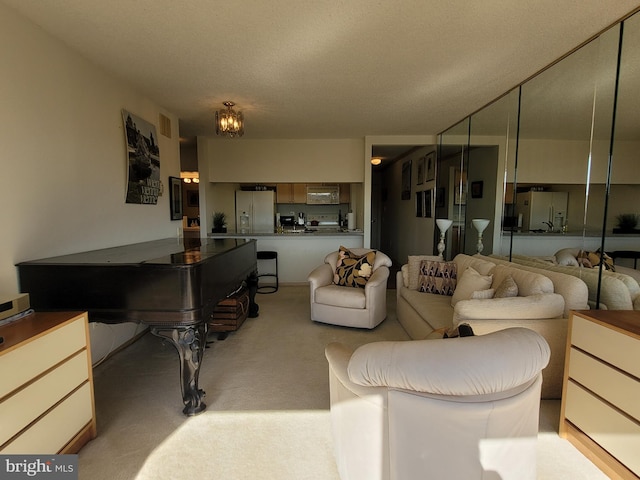 living room with a textured ceiling and light carpet