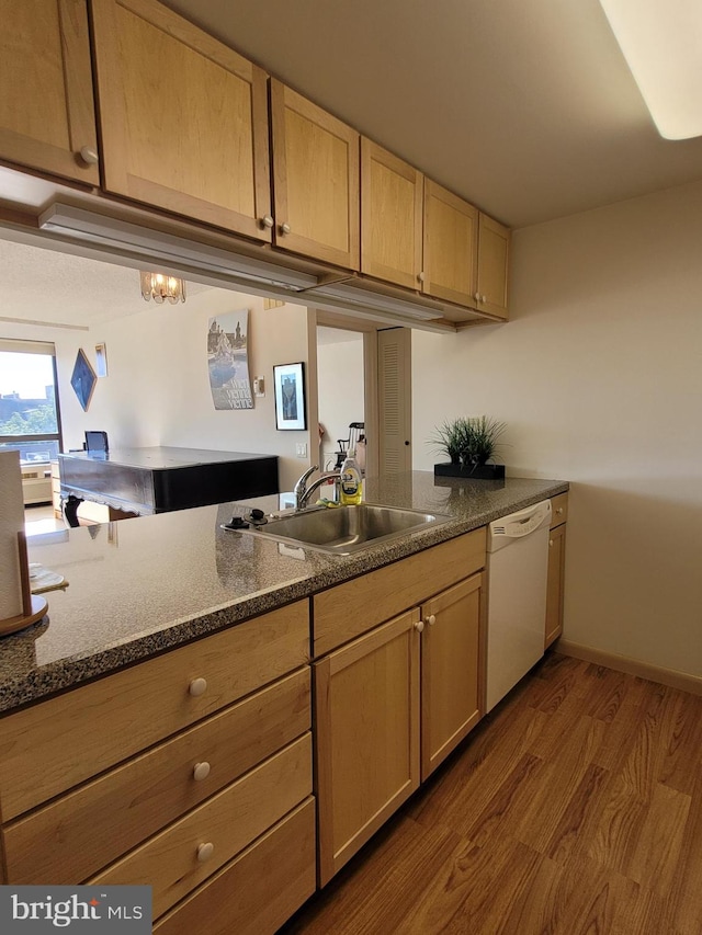 kitchen featuring light brown cabinets, sink, hardwood / wood-style flooring, dishwasher, and kitchen peninsula