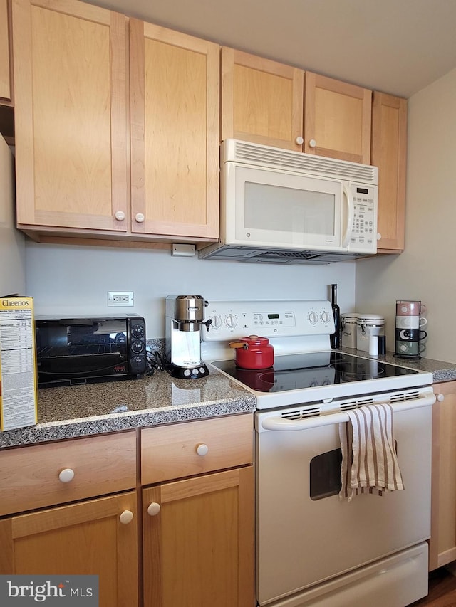 kitchen with light brown cabinets and white appliances