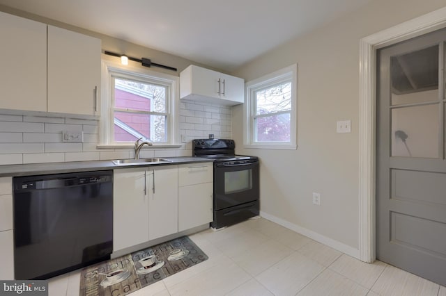 kitchen featuring a healthy amount of sunlight, decorative backsplash, white cabinets, and black appliances