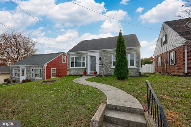 bungalow-style home featuring a front yard