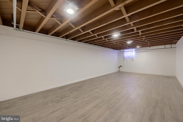 basement with hardwood / wood-style floors