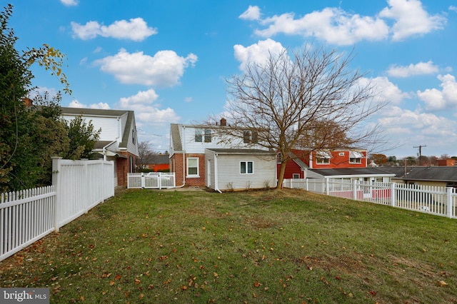 back of house with a yard