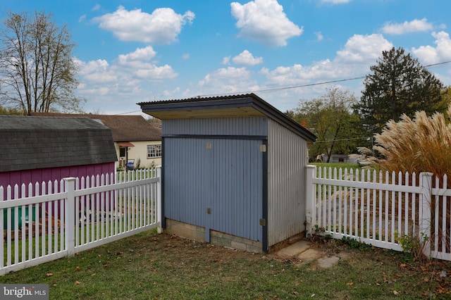 view of outbuilding with a lawn