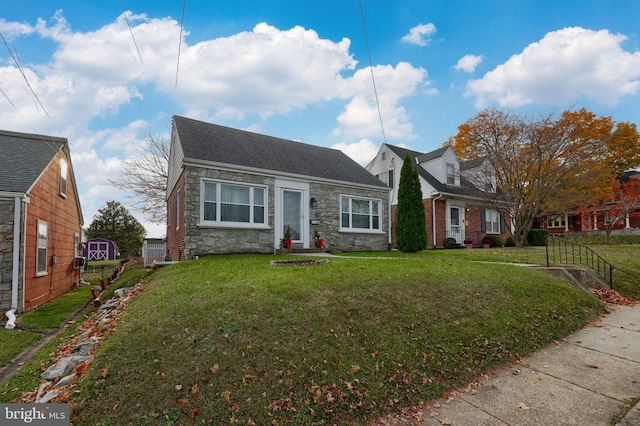 cape cod house with a front yard