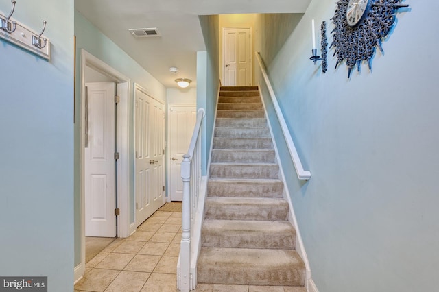 stairs with tile patterned flooring