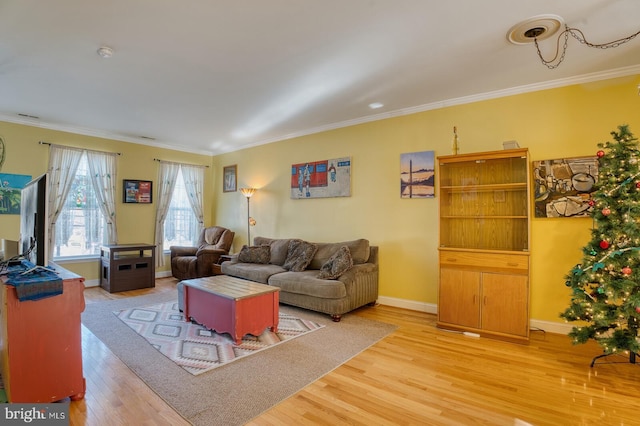 living room with hardwood / wood-style flooring and crown molding