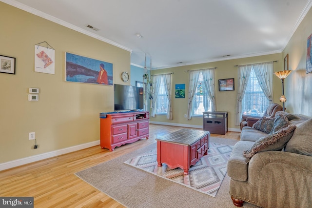 living room featuring ornamental molding and light wood-type flooring