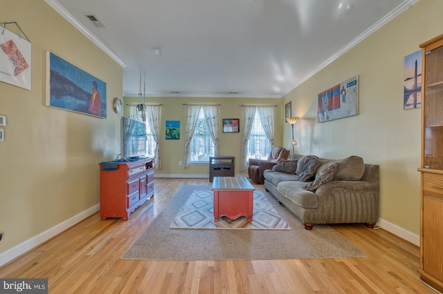 living room with crown molding and light hardwood / wood-style flooring