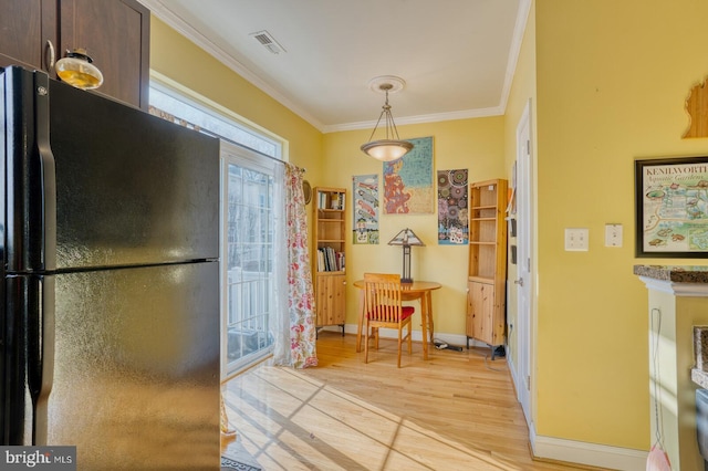 interior space featuring light hardwood / wood-style floors and ornamental molding