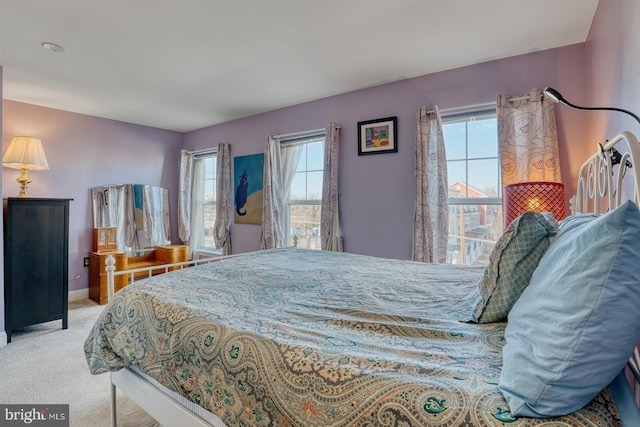 carpeted bedroom featuring multiple windows