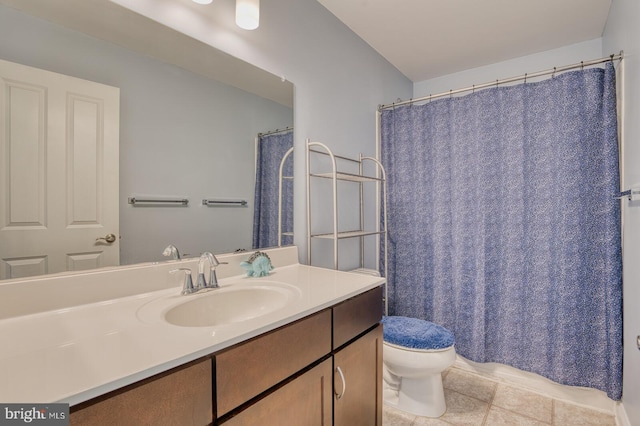 bathroom with tile patterned floors, vanity, and toilet