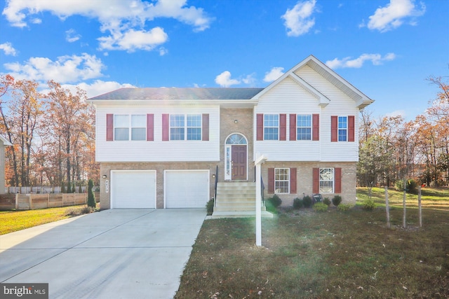 raised ranch featuring a front yard and a garage