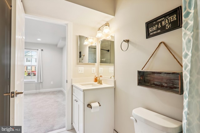 bathroom featuring vanity and toilet