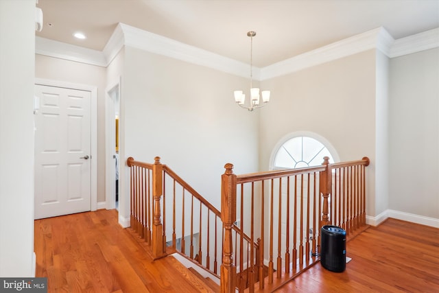 4639 Pendall Dr, Fort Washington, MD 20744 - hallway with an upstairs landing, wood finished floors, ornamental molding, a chandelier, and baseboards