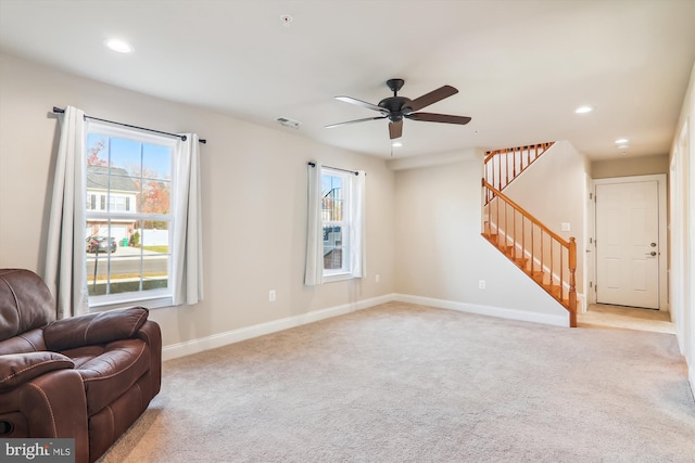 living room featuring light carpet and ceiling fan