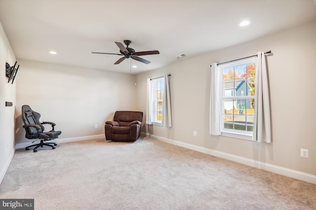 unfurnished room featuring ceiling fan and light colored carpet