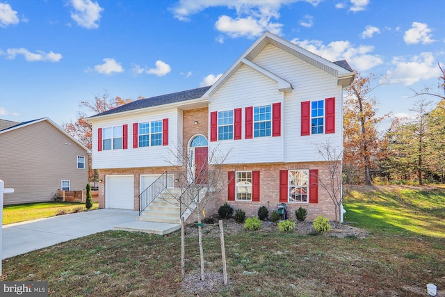 bi-level home featuring a front yard and a garage