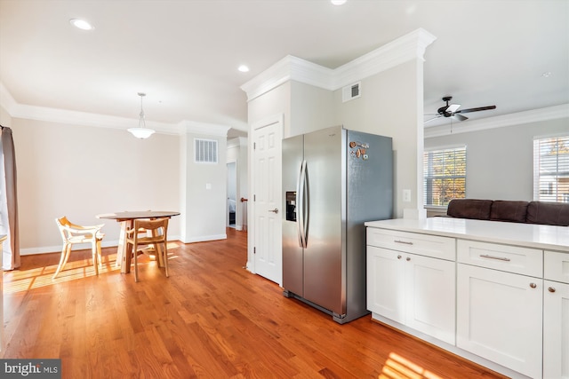 kitchen featuring white cabinets, stainless steel fridge with ice dispenser, light wood-type flooring, and crown molding