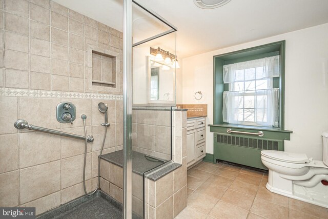 2209 Swamp Rd, Furlong, PA 18925 - bedroom with radiator heating unit, wood-type flooring, and a closet
