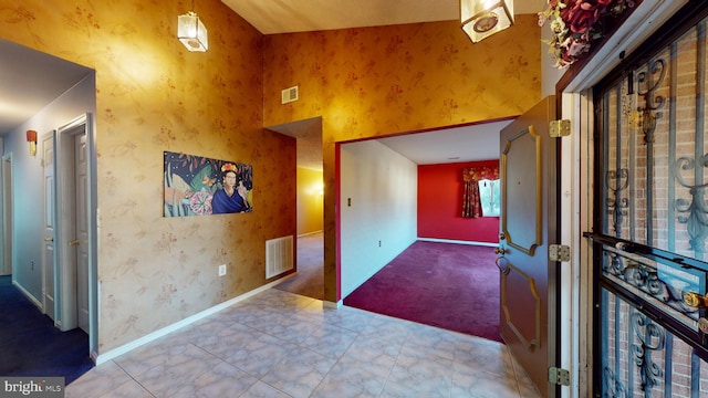 foyer featuring a towering ceiling