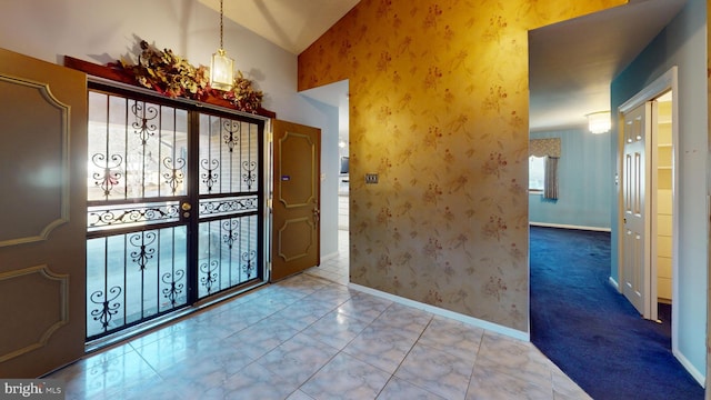 tiled foyer entrance with vaulted ceiling