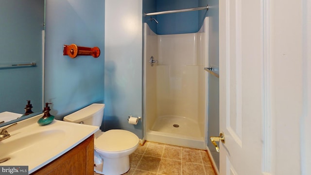 bathroom featuring vanity, toilet, and walk in shower