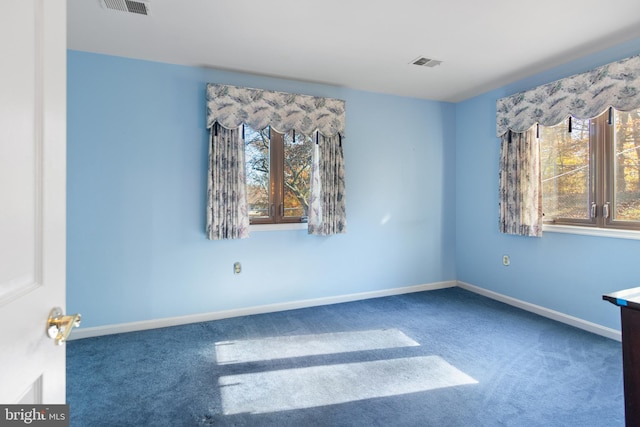 empty room with dark carpet