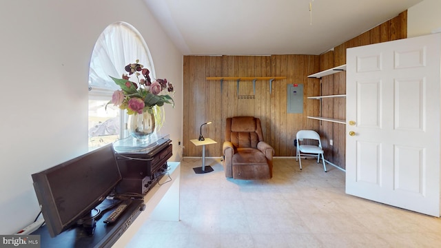 sitting room featuring wooden walls