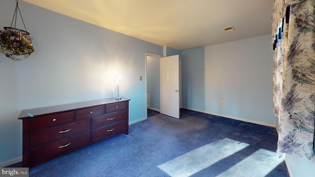 bedroom featuring dark carpet