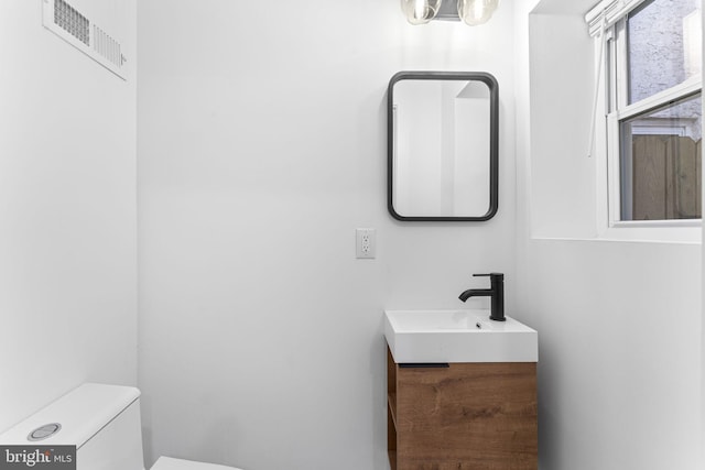 bathroom featuring vanity and toilet