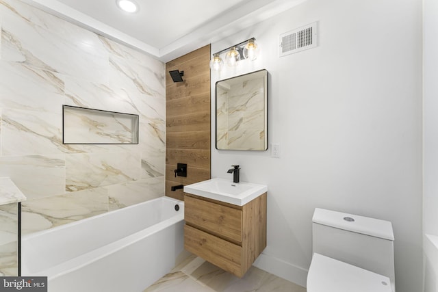 full bathroom with toilet, vanity, and tiled shower / bath