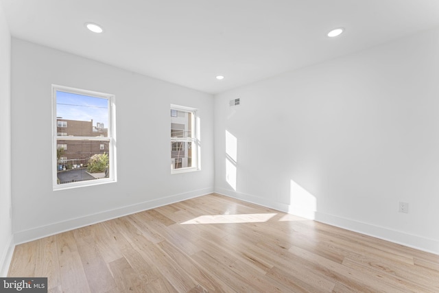 spare room with light hardwood / wood-style floors