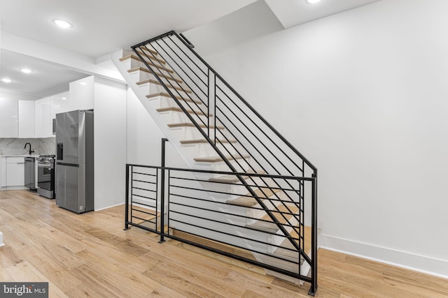 staircase featuring hardwood / wood-style floors