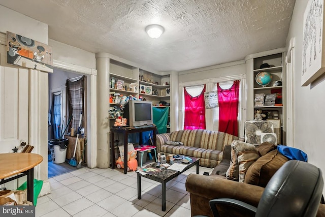 tiled living room featuring a textured ceiling