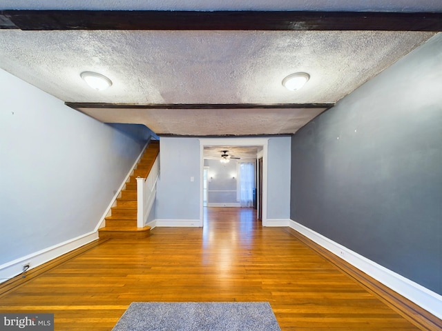 interior space featuring hardwood / wood-style floors, ceiling fan, and a textured ceiling