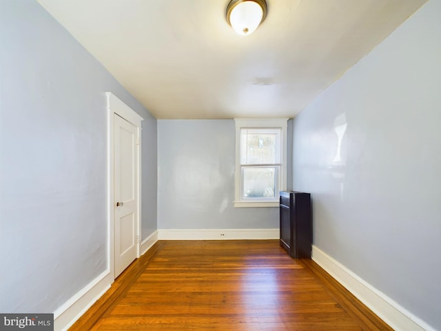 unfurnished room featuring dark wood-type flooring