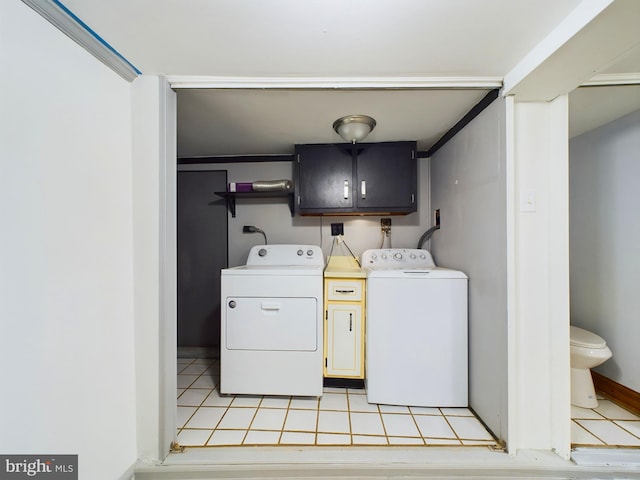 washroom with light tile patterned flooring, cabinets, and separate washer and dryer