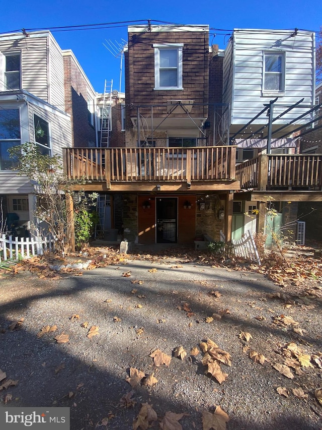 back of property with a wooden deck