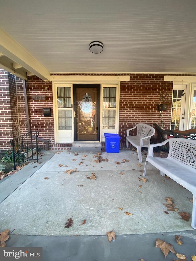 entrance to property featuring a patio area