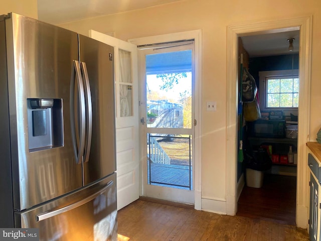 kitchen featuring dark wood-type flooring and stainless steel fridge with ice dispenser