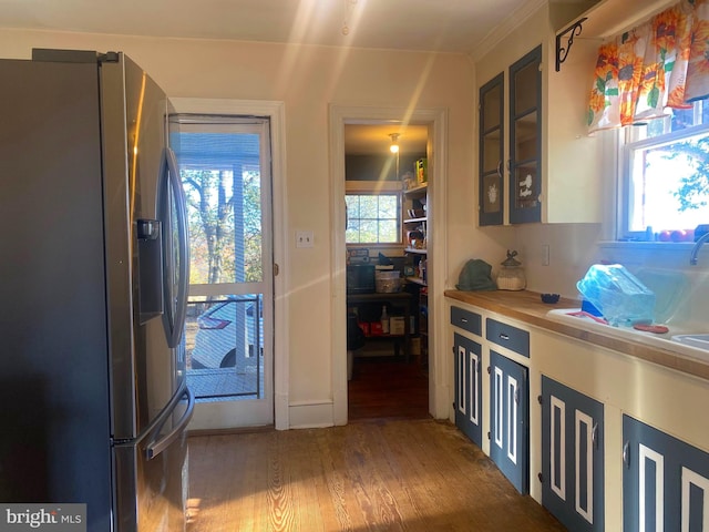 kitchen featuring stainless steel refrigerator with ice dispenser, dark hardwood / wood-style flooring, and butcher block countertops