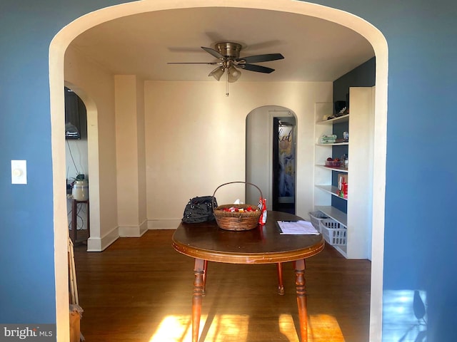 dining area with dark wood-type flooring and ceiling fan