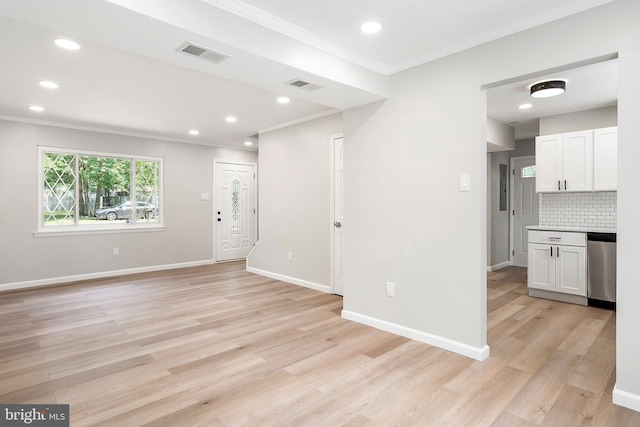 unfurnished living room with light wood-type flooring and ornamental molding