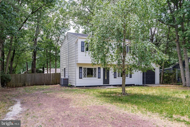 view of front of home featuring a garage and cooling unit